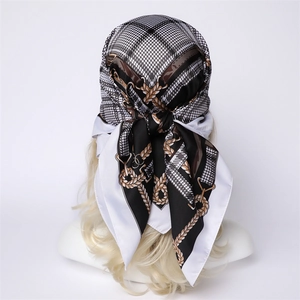 Detail of checkered square silk scarf featuring luxury chain print and vintage patterns