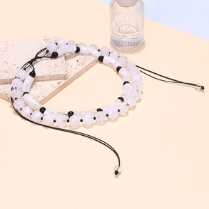 Detailed macro of translucent jelly tube beads and white round stones on a double-layer necklace
