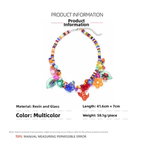 Detail of colorful resin beads with flower, cactus and butterfly charms on the necklace