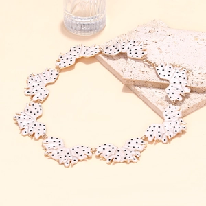 Detail of enamel leaf necklace with black polka dots and adjustable lobster clasp
