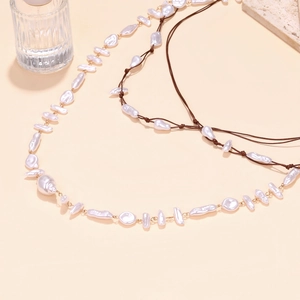 Barock-Perlenkette im Layering-Look mit Goldkette und dunkelbrauner geknoteter Kordel