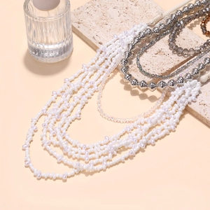 Handmade multi-layer layered beaded necklace with pearls and metallic beads on stone