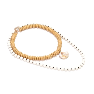 Detail of bohemian layered necklace with wooden beads and a textured conch shell pendant