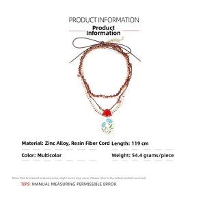 Detail view of 119cm multi-layer beaded necklace with enamel floral resin pendants