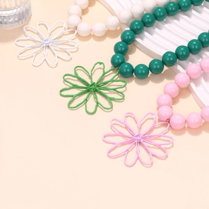 Handmade beaded flower pendant necklaces in white, green, and pink for a summer resort style