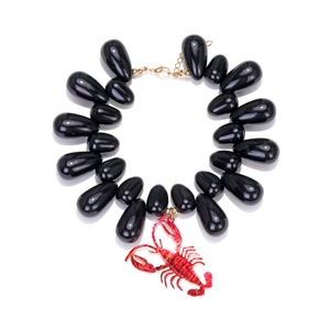 Detail of red crayfish pendant and black teardrop beads on ocean style necklace