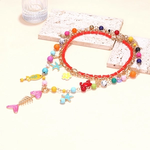 Collier superposé fait main avec perles et pendentifs de poisson tropical et étoile de mer