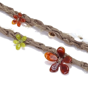 Macro shot of handcrafted woven rope texture with colorful resin floral pendants