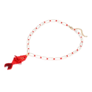 Detailed view of handmade beaded necklace featuring a red woven fish pendant and lobster clasp