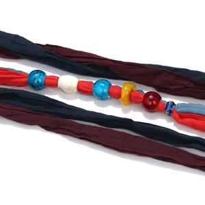 Handmade tie-dye fabric necklace with gradient colors and artisanal glass beads