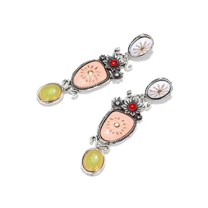 Detail of vintage enamel floral earrings with silver alloy and multicolor stones