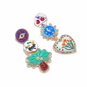 Bohemian asymmetric colorful enamel earrings with palm tree and evil eye charms on white background