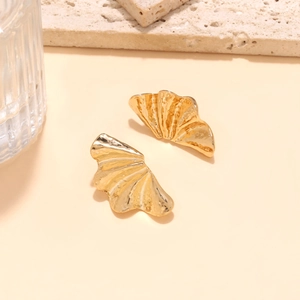 Golden leaf earrings with hammered texture and irregular folding on stone base