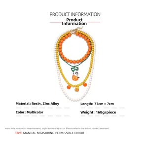 Detailed view of 77cm multi-layer beaded necklace with pumpkin and BOO charms
