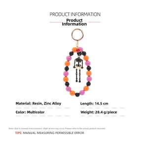 Detail view of Halloween keychain featuring resin beads and skeleton charm with measurements