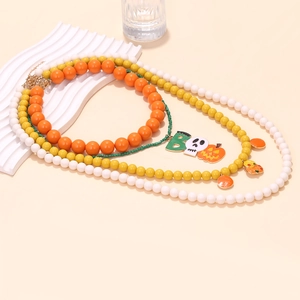 Close-up of Halloween triple layered beaded necklace with BOO pumpkin pendant