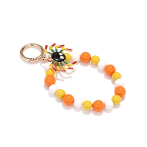 Detail of beaded Halloween spider keychain with vibrant orange beads and lobster clasp