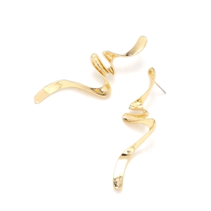 Detailed macro view of golden twisted spiral ribbon earrings with reflective mirror finish