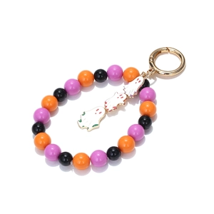 Detail of Halloween keychain featuring orange purple beads and white enamel ghost charms
