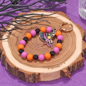 Halloween beaded keychain featuring purple and orange beads with a black witch hat charm