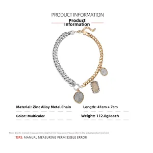 Detail view of two-tone thick chain necklace with geometric coin pendants and engraving