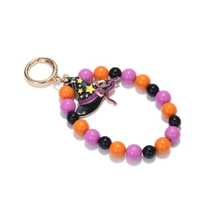 Close-up of Halloween beaded keychain with orange and purple beads and a wizard hat pendant