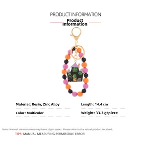 Detailed view of Halloween beaded keychain with haunted house charm and measurement data