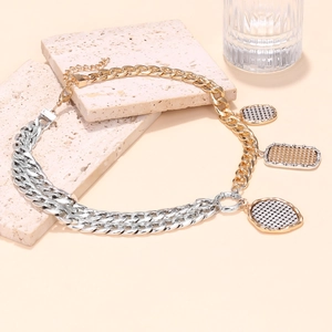 Detail of two-tone gold and silver chunky chain necklace with textured coin pendants