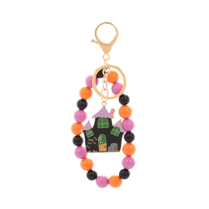 Detail of Halloween keychain with orange beads and black enamel haunted house charm