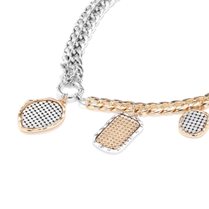 Detail of two-tone chain necklace with geometric pendants featuring textured patterns