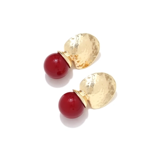Minimalist geometric drop earrings with gold hammered discs and red resin spheres
