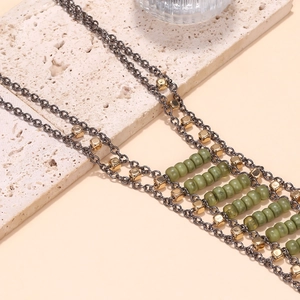 Multilayer bohemian necklace with green beads and dark gray metal fringe chain