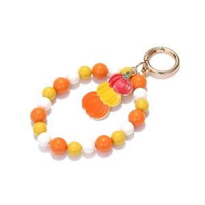 Detail of Halloween beaded keychain with pumpkin charms and golden spring ring clasp