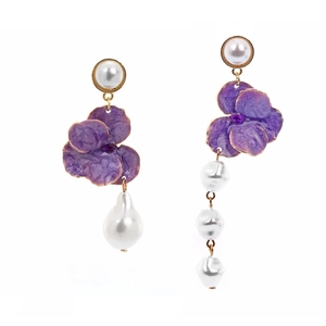 Detail of asymmetric purple enamel flower earrings with baroque pearls and violet gems