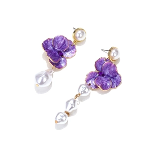 Detailed shot of asymmetric purple enamel flower earrings with baroque pearls and gold plating