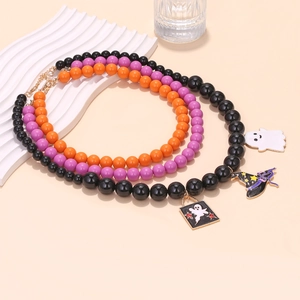 Halloween beaded necklace set with ghost and wizard hat pendants on a neutral background