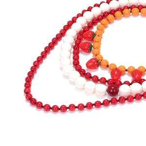 Multilayer beaded necklace with colorful beads and strawberry charms on white background