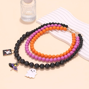 Detailed view of Halloween layered beaded necklaces with ghost and witch hat pendants