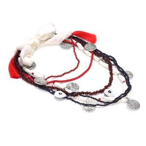 Multilayer beaded necklace with red tassels and evil eye charms on white background
