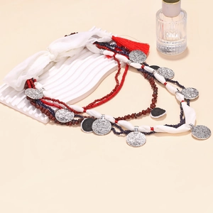 Bohemian multi-layer beaded necklace with silver charms and vibrant red tassels