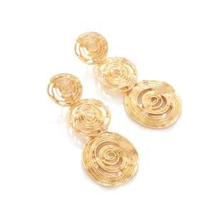 Macro detail of gold alloy spiral textured triple round drop earrings with hollow design