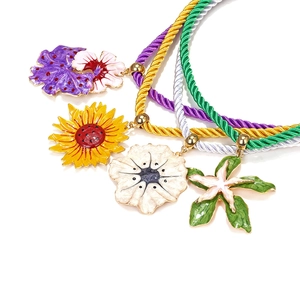 Set of four colorful enamel sunflower and floral pendant necklaces on braided ropes