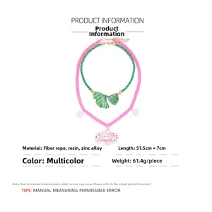 Detail of multi-layer flower and leaf necklace with resin charms and cord chain