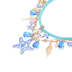 Detail of beaded marine necklace featuring enamel starfish, dolphin and gold shell charms