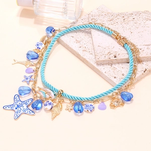 Detail of beaded layered necklace featuring starfish pendants and ceramic charms