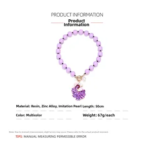Detail view of purple resin beaded necklace with flower pendant and imitation pearl drop