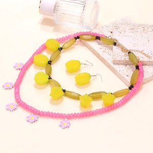 Layered floral necklace set with pink daisy pendant and yellow starfruit beads