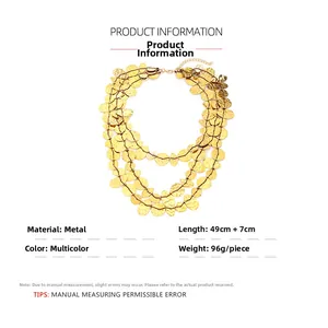 Macro detail of multi-layered gold waterfall tassel necklace with irregular metal sequins