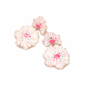 Close-up of pink enamel flower earrings with gold metal edges and colorful petal details