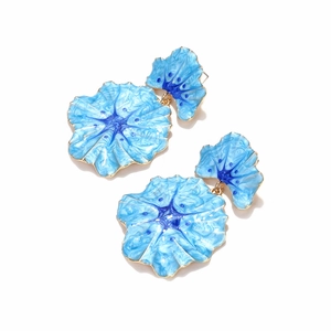 Detail of blue enamel flower earrings with intricate textures and gold metal edges